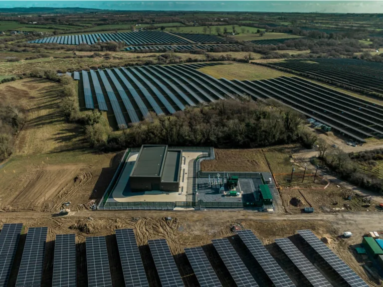 Aerial view of expansive solar farm infrastructure.